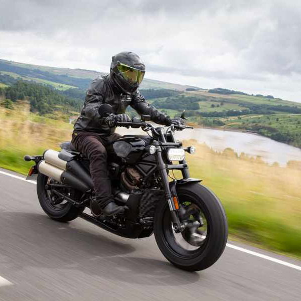A black 2021 Harley-Davidson Sportster S being ridden down a country road